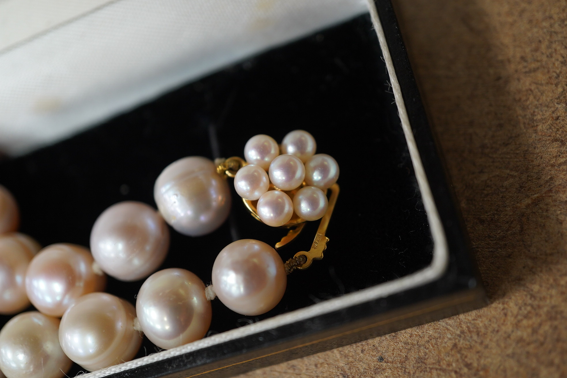 A modern single strand cultured pearl necklace, with cultured pearl cluster set 9ct clasp. Condition - fair to good